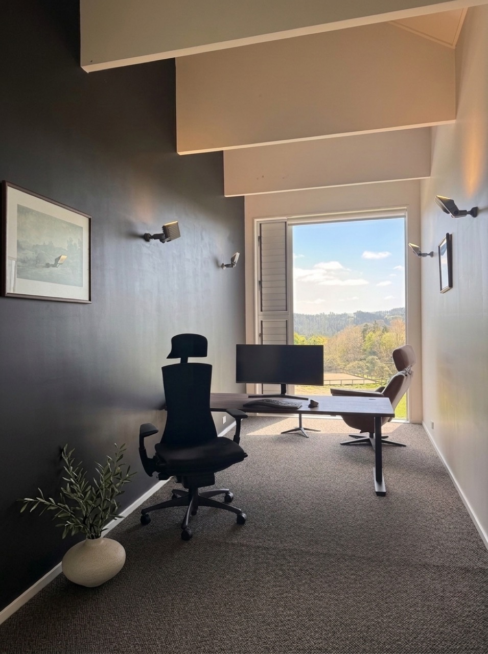 Dedicated upstairs study with executive desk, ultrawide monitor, high-speed Starlink internet, ergonomic chair, leather reading chair, new plush carpet, and window overlooking the sand arena and hills